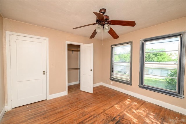 408 E Ebony St, La Feria, TX 78559 - unfurnished bedroom with wood finished floors, ceiling fan, and a closet