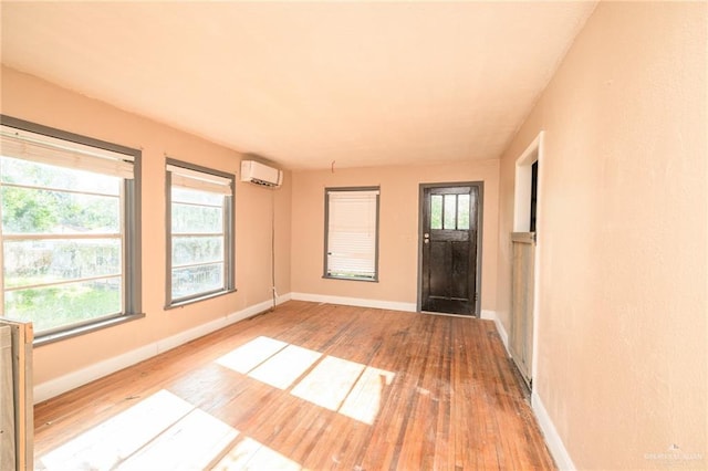 408 E Ebony St, La Feria, TX 78559 - entryway with hardwood / wood-style floors, plenty of natural light, and an AC wall unit