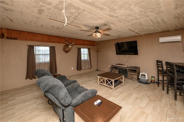 408 E Ebony St, La Feria, TX 78559 - living room with a wall mounted air conditioner, wood finished floors, and a ceiling fan