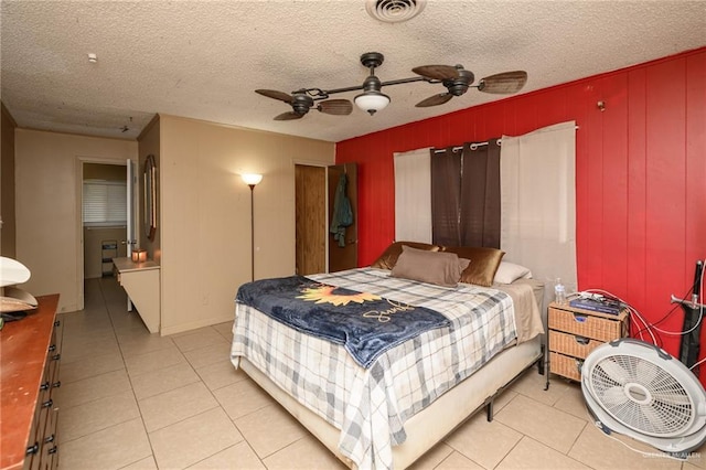 408 E Ebony St, La Feria, TX 78559 - bedroom with light tile patterned floors, ceiling fan, and a textured ceiling