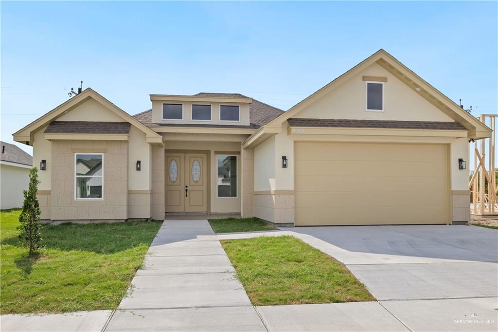 1904 Diplomat Dr, Edinburg, TX 78542 - view of front of house with a shingled roof and stucco siding