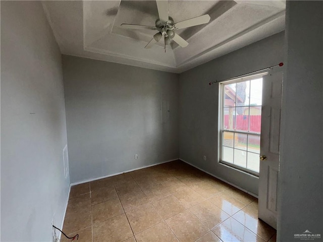 1708 Ivory St, Edinburg, TX 78541 - empty room with a raised ceiling, healthy amount of natural light, light tile patterned floors, and a ceiling fan