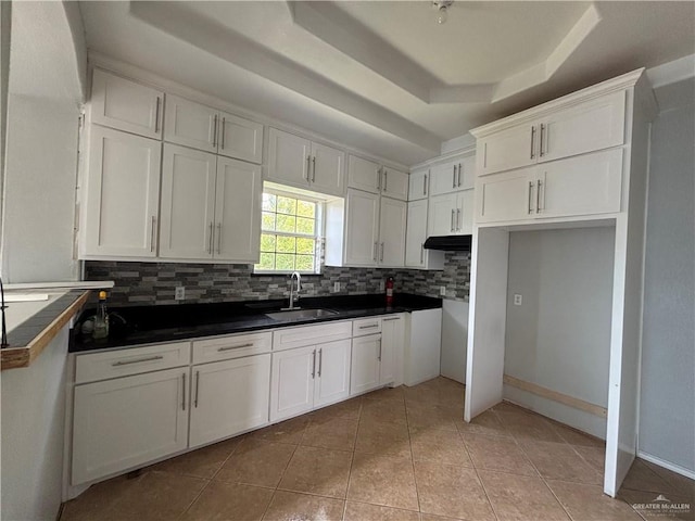 1708 Ivory St, Edinburg, TX 78541 - kitchen featuring a sink, a raised ceiling, backsplash, and light tile patterned flooring