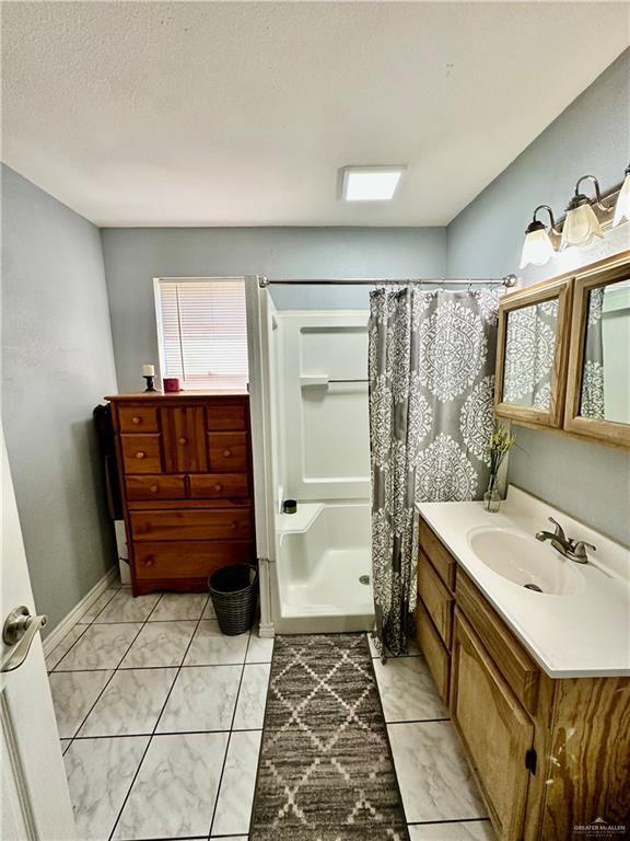 full bathroom featuring vanity and a shower with shower curtain