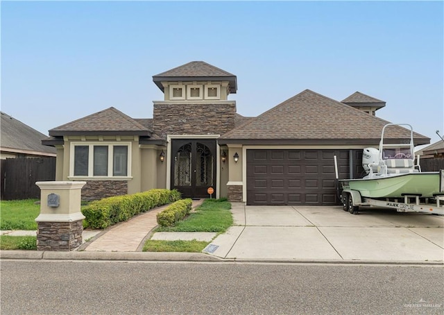 5001 N Ebony St, Pharr, TX 78577 - view of front of home with stone siding, an attached garage, and stucco siding