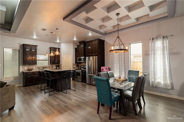 5001 N Ebony St, Pharr, TX 78577 - dining area with a chandelier, coffered ceiling, baseboards, wood finished floors, and recessed lighting