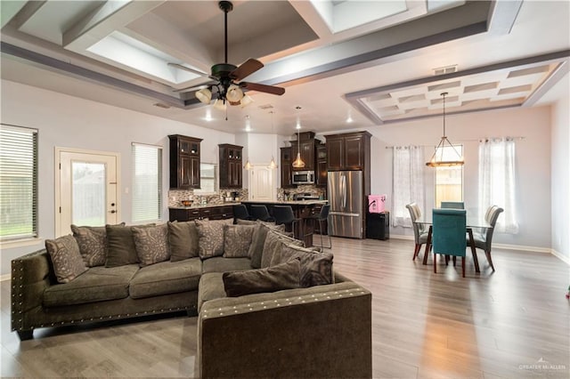 5001 N Ebony St, Pharr, TX 78577 - living room featuring coffered ceiling, baseboards, a ceiling fan, light wood-style floors, and a raised ceiling