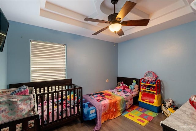 5001 N Ebony St, Pharr, TX 78577 - bedroom featuring wood finished floors, a tray ceiling, and a ceiling fan