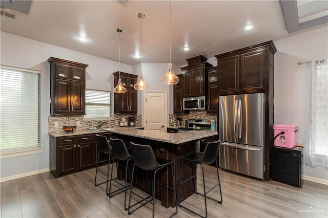 5001 N Ebony St, Pharr, TX 78577 - kitchen featuring stainless steel appliances, light wood finished floors, baseboards, dark brown cabinetry, and recessed lighting