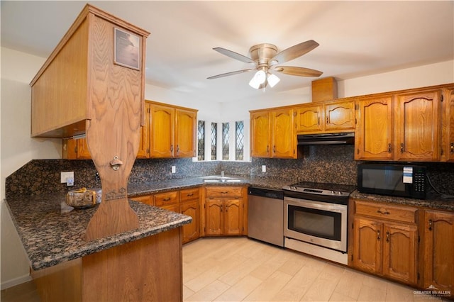 kitchen featuring stainless steel appliances, ceiling fan, dark stone countertops, kitchen peninsula, and range hood