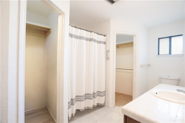 bathroom with tile patterned floors and vanity