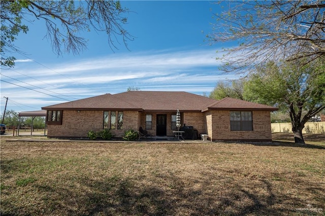 single story home with a carport and a front yard