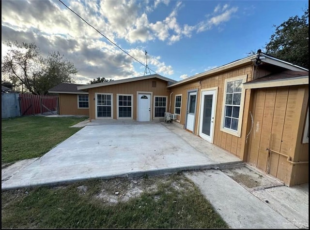 rear view of house featuring a yard and a patio