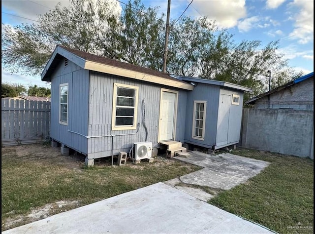 exterior space with ac unit and a yard