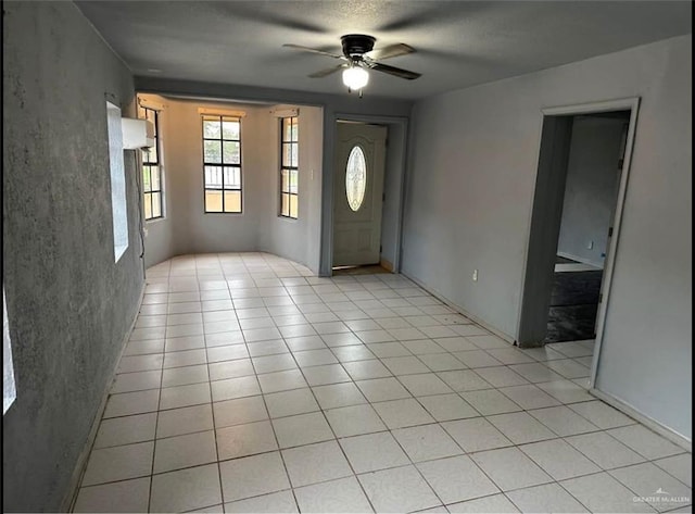 tiled entrance foyer featuring ceiling fan