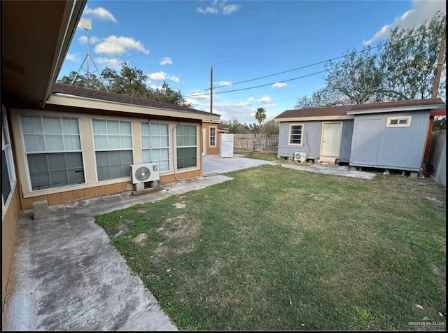 view of yard featuring ac unit, a storage unit, and a patio area