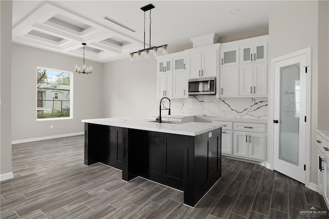 4911 Aguajito St, Edinburg, TX 78542 - kitchen with wood-type flooring, sink, and an island with sink