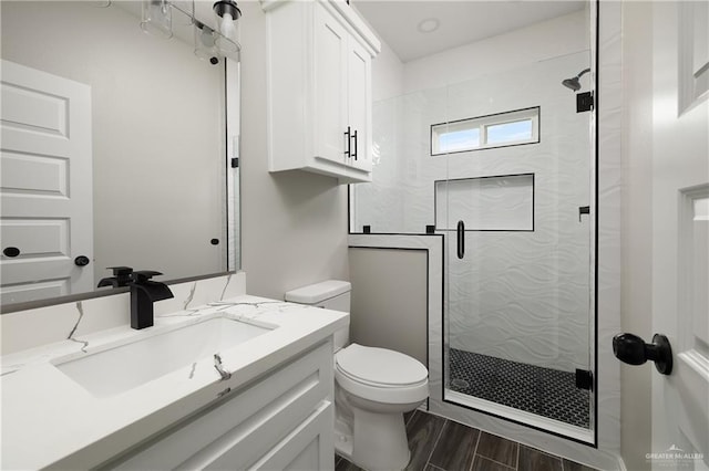 4911 Aguajito St, Edinburg, TX 78542 - bathroom with walk in shower, toilet, vanity, and hardwood / wood-style flooring