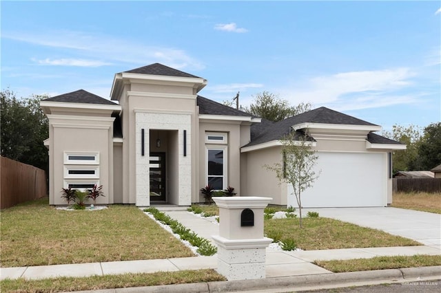 prairie-style home featuring a garage and a front yard