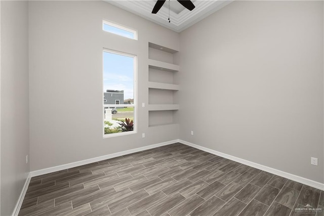 4911 Aguajito St, Edinburg, TX 78542 - spare room with ceiling fan, built in features, a healthy amount of sunlight, and dark hardwood / wood-style floors