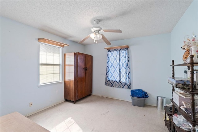 bedroom featuring a textured ceiling and ceiling fan