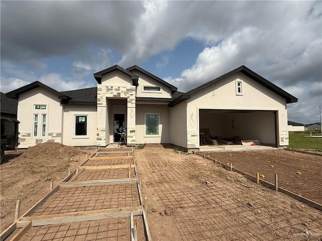 132 Finch Ln, Los Fresnos, TX 78566 - ranch-style home with a vegetable garden, stucco siding, stone siding, a garage, and driveway