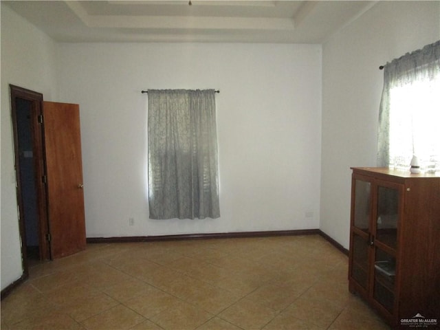 5401 Sunny Cir, Mission, TX 78574 - tiled empty room featuring a raised ceiling and baseboards