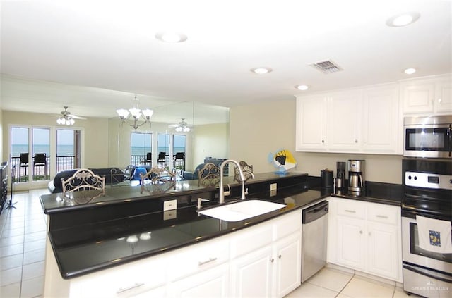 3400 Gulf Blvd Unit 403, South Padre Island, TX 78597 - kitchen featuring stainless steel appliances, light tile patterned floors, a ceiling fan, a peninsula, and recessed lighting
