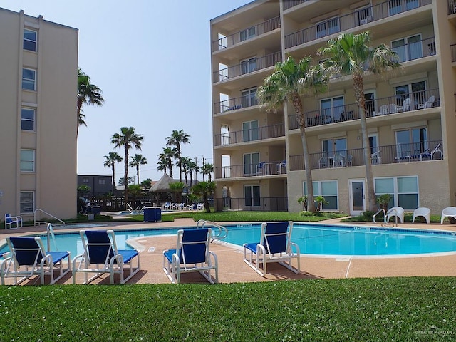 3400 Gulf Blvd Unit 403, South Padre Island, TX 78597 - community pool with a yard and a patio