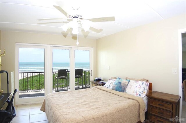3400 Gulf Blvd Unit 403, South Padre Island, TX 78597 - bedroom with access to exterior, a water view, light tile patterned floors, and ceiling fan