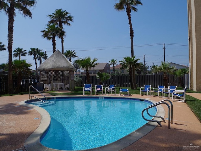 3400 Gulf Blvd Unit 403, South Padre Island, TX 78597 - community pool featuring a patio area