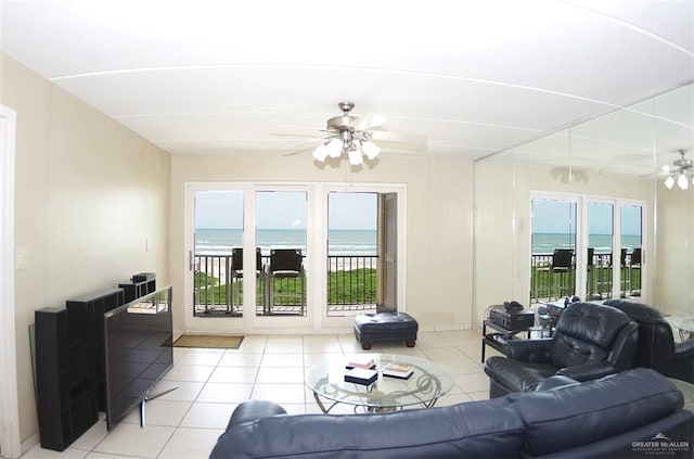 3400 Gulf Blvd Unit 403, South Padre Island, TX 78597 - living room with ceiling fan, light tile patterned floors, a water view, and plenty of natural light