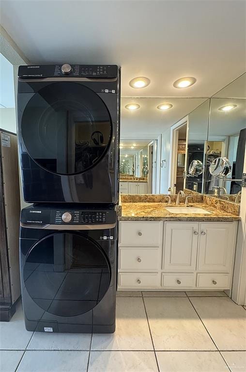 3400 Gulf Blvd Unit 403, South Padre Island, TX 78597 - laundry area featuring stacked washing machine and dryer and light tile patterned flooring