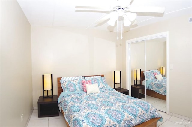 3400 Gulf Blvd Unit 403, South Padre Island, TX 78597 - bedroom with light tile patterned floors, a closet, and a ceiling fan