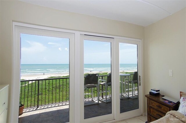 3400 Gulf Blvd Unit 403, South Padre Island, TX 78597 - tiled bedroom featuring access to exterior and view of water and beach