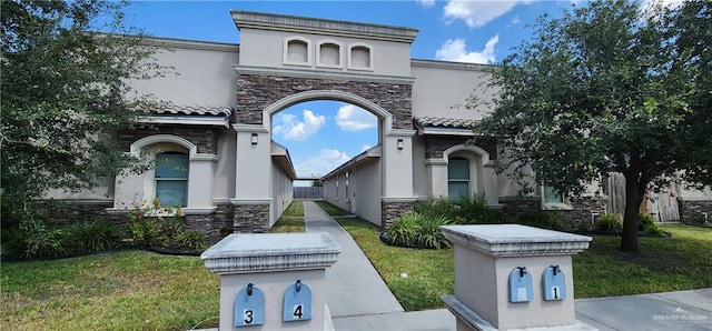 mediterranean / spanish-style home with a front lawn