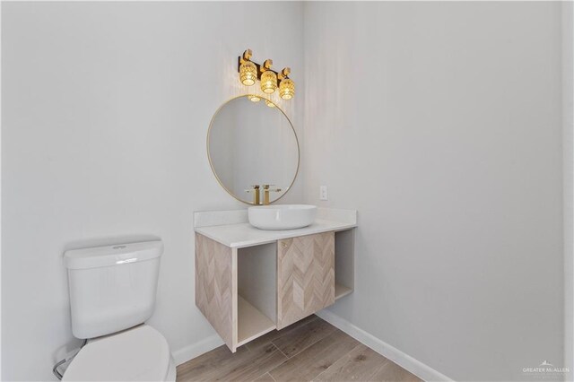 bathroom featuring hardwood / wood-style floors, vanity, and toilet