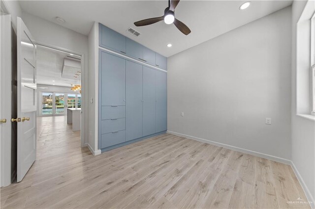 unfurnished bedroom with ceiling fan, light hardwood / wood-style floors, and a closet