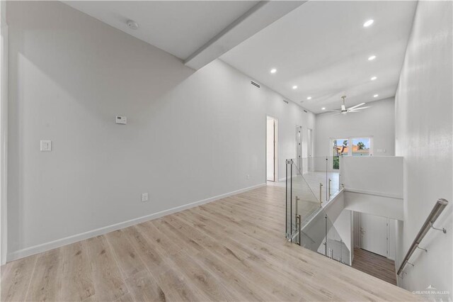 interior space featuring a high ceiling and light hardwood / wood-style flooring