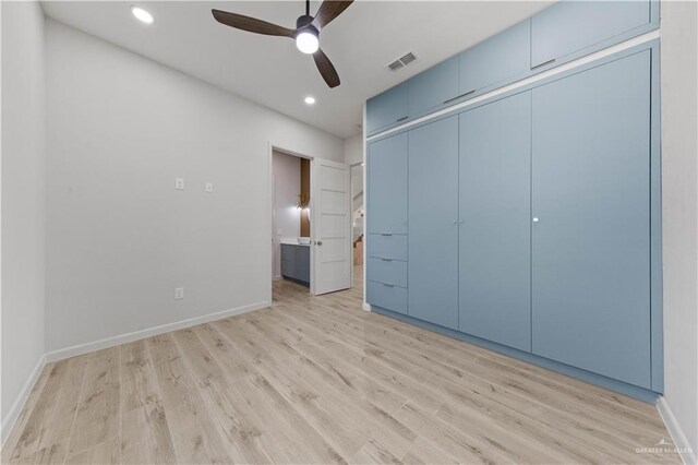 unfurnished bedroom with ceiling fan, light hardwood / wood-style flooring, and a closet