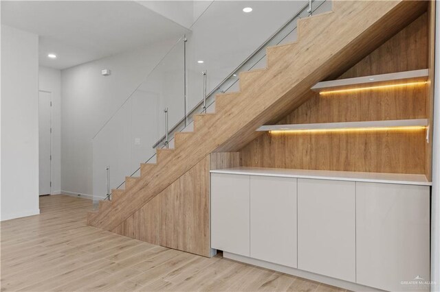 stairway featuring hardwood / wood-style floors and a towering ceiling