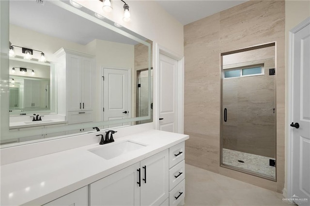 full bath featuring a stall shower and vanity