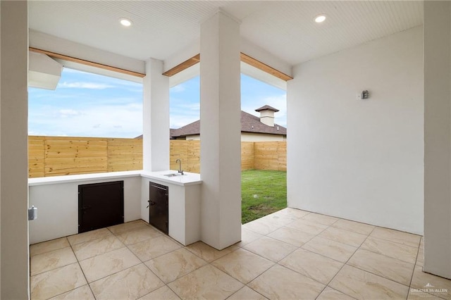 view of patio / terrace with fence and a sink