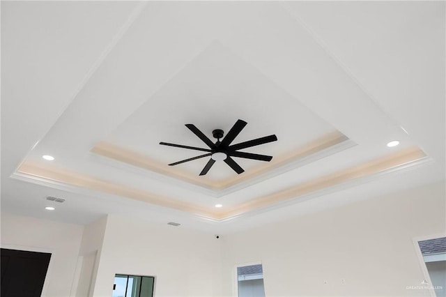 interior details featuring a tray ceiling, a ceiling fan, visible vents, and recessed lighting