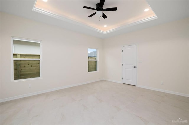 spare room featuring ceiling fan, baseboards, a raised ceiling, and recessed lighting