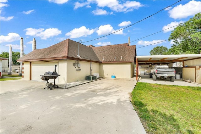 view of property exterior with a carport, cooling unit, and a lawn