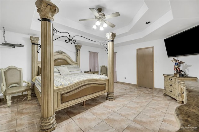 bedroom with a raised ceiling and ceiling fan