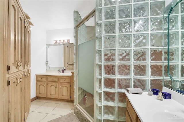 bathroom featuring tile patterned floors, vanity, and walk in shower