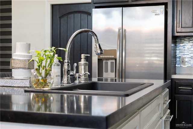 room details featuring stainless steel refrigerator with ice dispenser