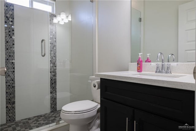 full bath with vanity, toilet, and a shower stall